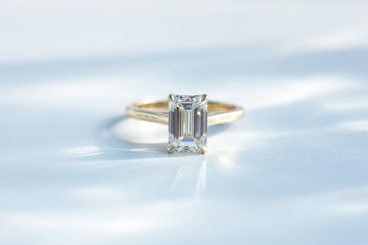 Emerald cut diamond solitaire in yellow gold