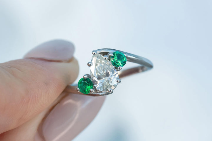 Pear Shaped Diamond and Emerald Twist Engagement Ring in Platinum