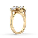 A yellow gold ring with a large round brilliant-cut diamond center stone and smaller round diamonds along the shoulders, shown on a clean white background.