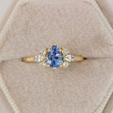 Pear blue sapphire cluster ring with round and marquise shape white diamonds in 18K yellow gold by Amy Jennifer Jewellery